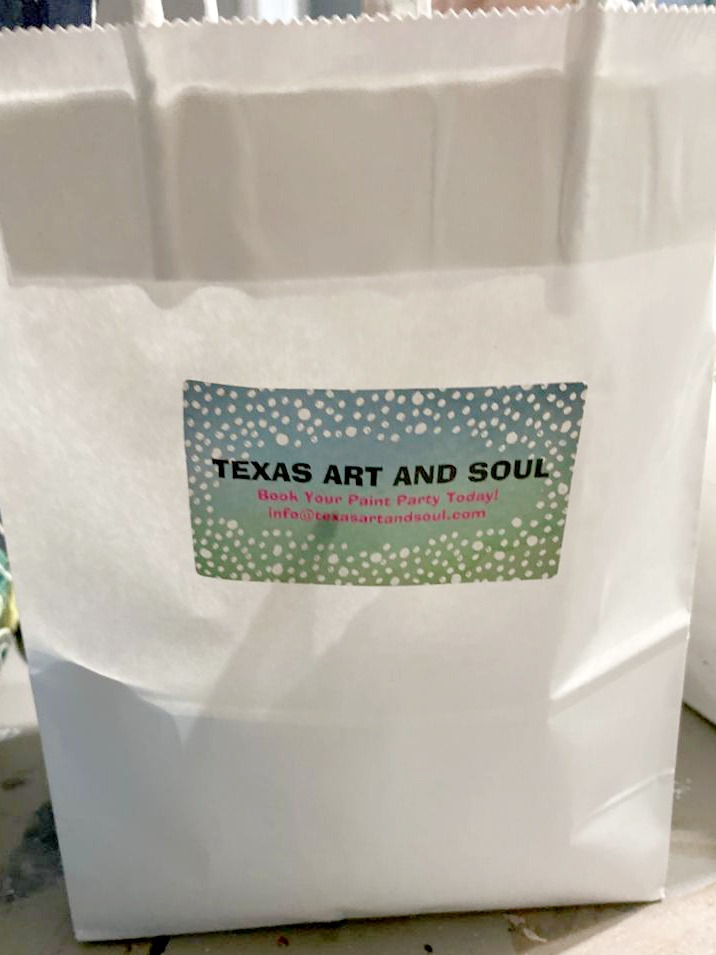 white gift bag with Texas Art and Soul sticker - paint party online goodie bag